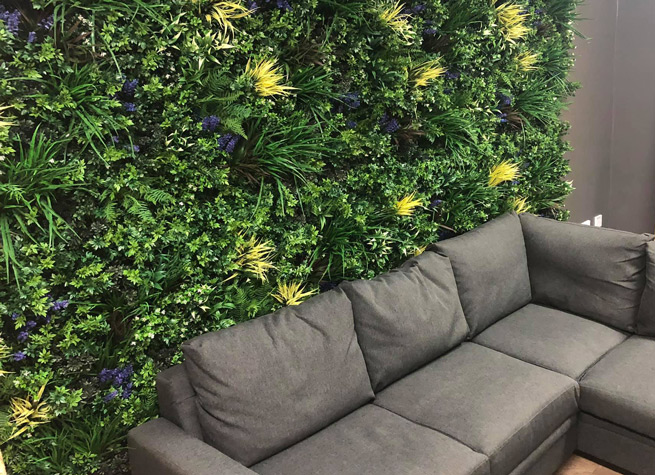interior green wall with comfy sofas