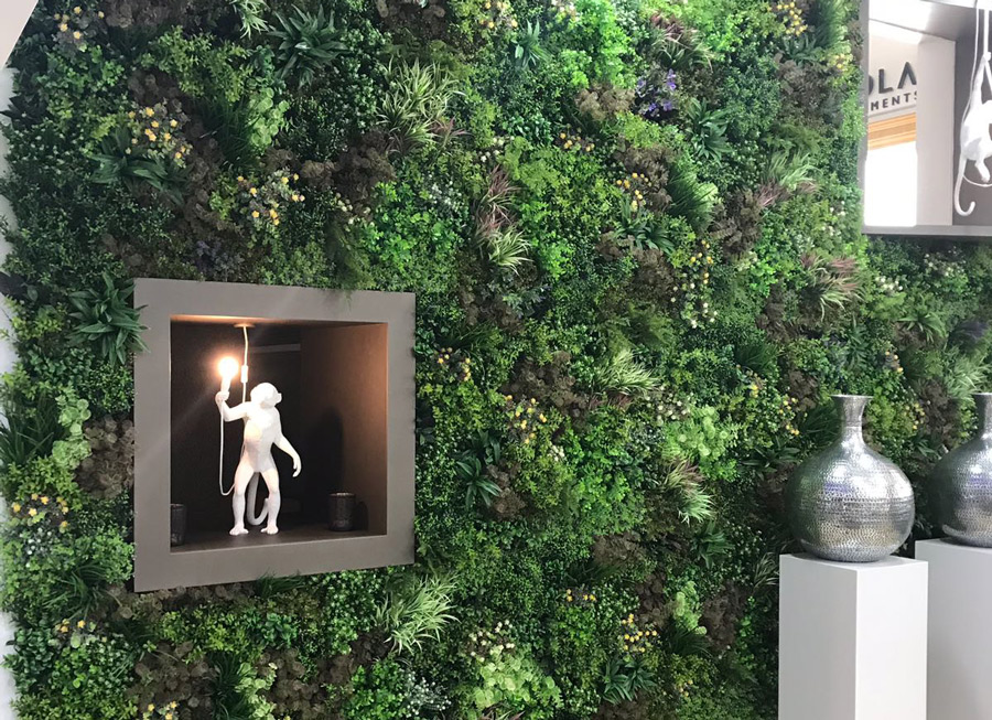 artificial green wall displaying artwork